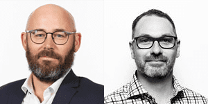 Two men with beards and glasses, side by side; the left man is bald and wearing a suit, while the right man has short hair and wears a checkered shirt. Both are facing forward against plain backgrounds.