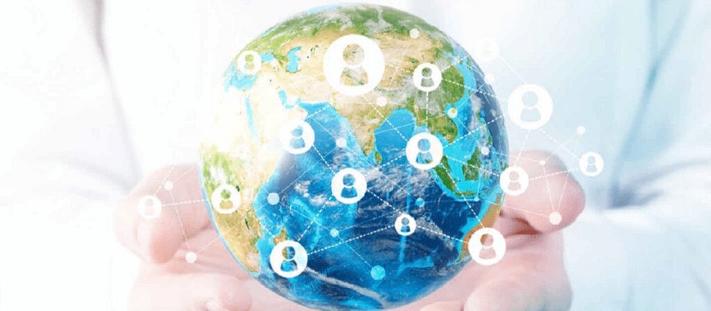 A person holds a digital image of the Earth with white user icons and connecting lines superimposed, representing global communication or social networking.