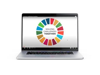 A laptop displaying a screen with a colorful circular graphic and the words Solving Challenges Together in the center.