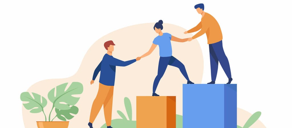 Three people help each other climb colorful blocks, with one person on the ground assisting another up, while a third person stands on a higher block, offering a hand. A green potted plant is on the left side.