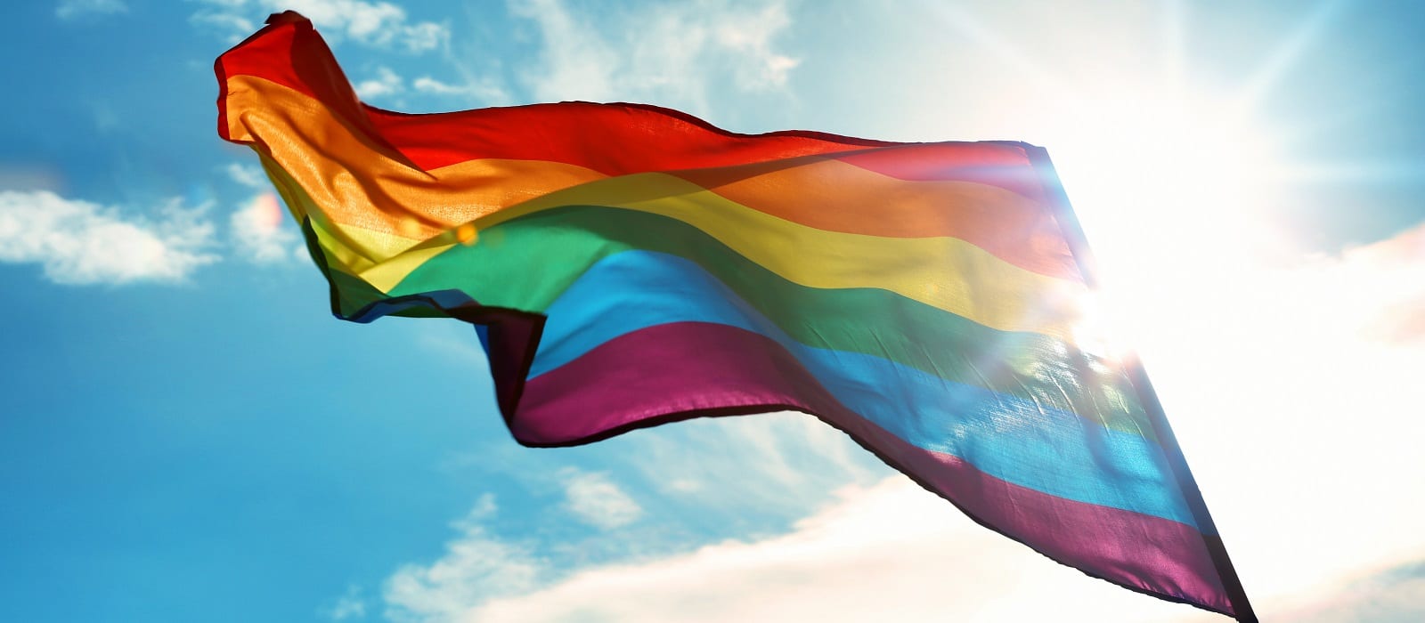 Gay flag on sky background