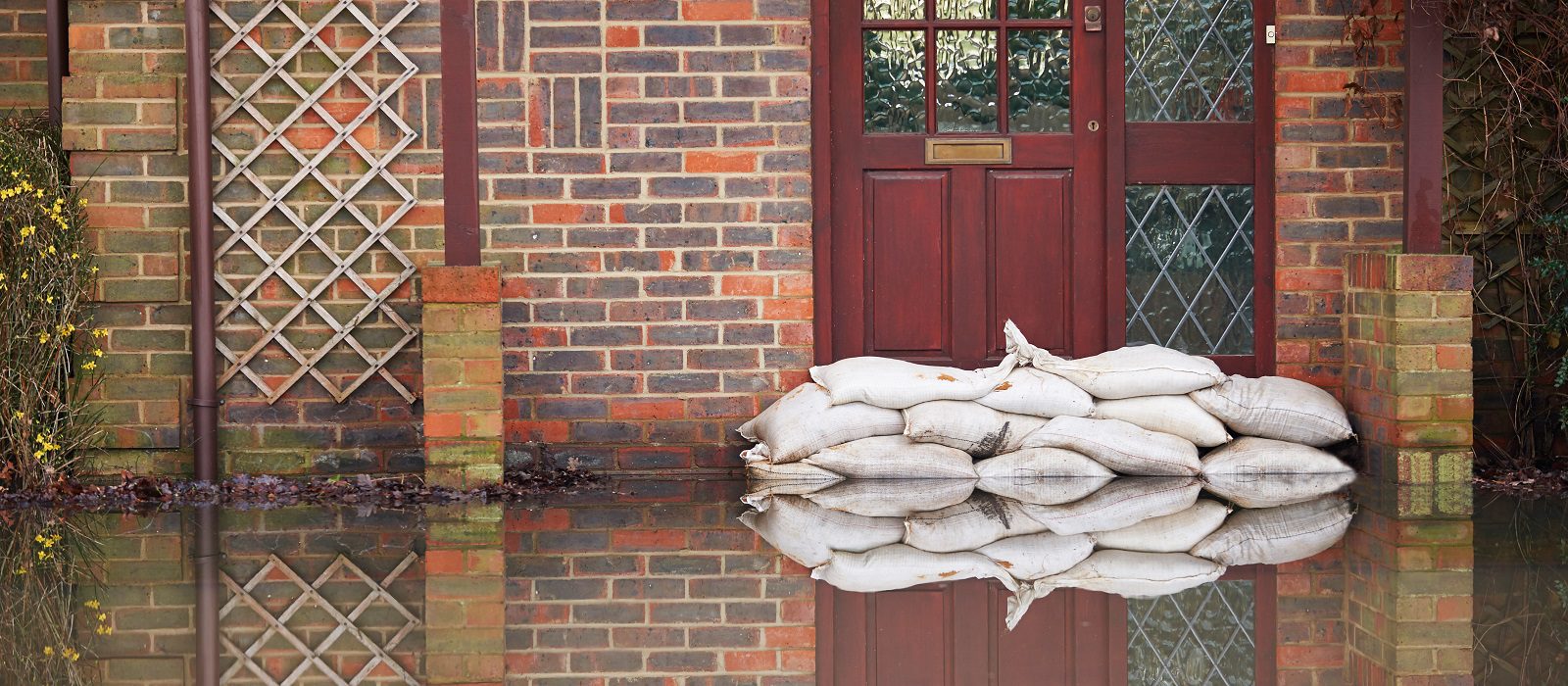Sandbags Outside Front Door Of Flooded House