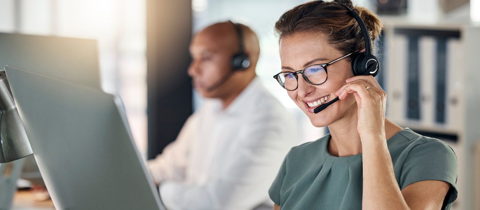 Customer service, call center and crm with a woman consultant working in a telemarketing office. Support, computer and sales with a female consulting using a headset for help, assist or communication.