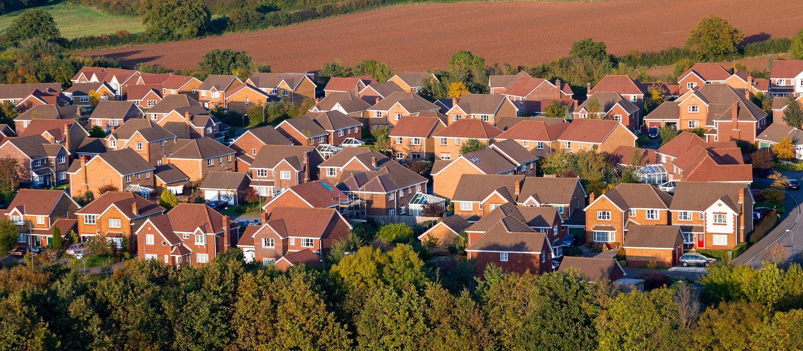 Modern, red brick houses viewed from above.