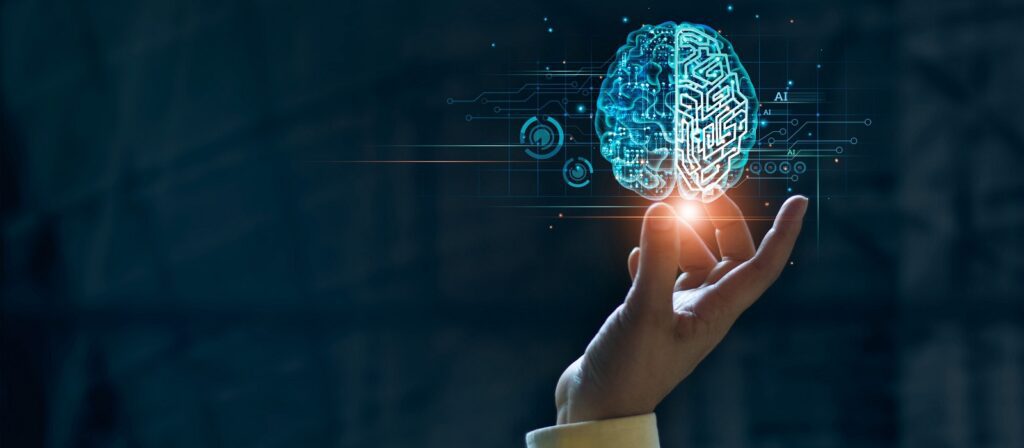 A hand reaching upward with a glowing digital illustration of a brain above it, surrounded by circuitry patterns, representing artificial intelligence and technology concepts.