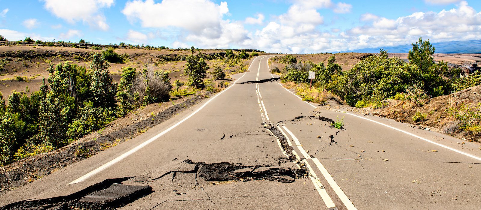 Damaged asphalt road Crater Rim Drive in the Hawaii Volcanoes National Park after earthquake and eruption of Kilauea