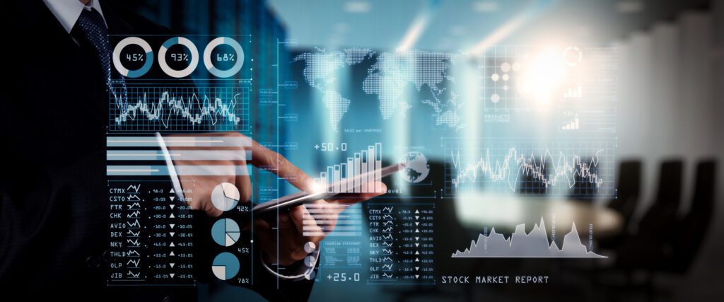 A person in business attire uses a tablet with financial graphs, charts, and data visualizations superimposed, representing stock market analysis and digital business analytics in a modern office setting.