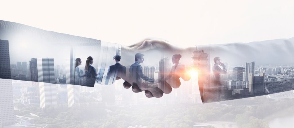 A double exposure image of two hands shaking, with a city skyline and silhouettes of business people overlaid, symbolizing business partnership and teamwork in an urban setting.