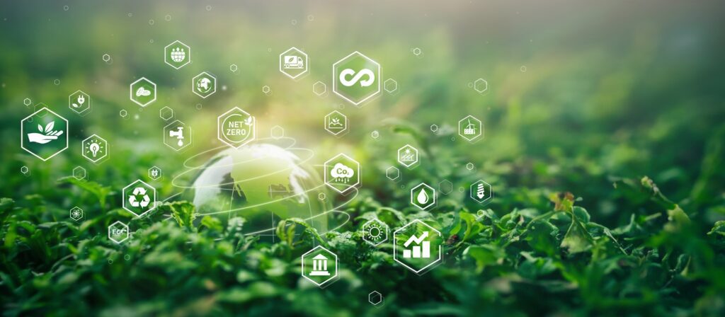 A glass globe rests on green grass, surrounded by floating sustainability and eco-friendly icons, representing concepts like recycling, net zero, carbon emissions, renewable energy, and growth.