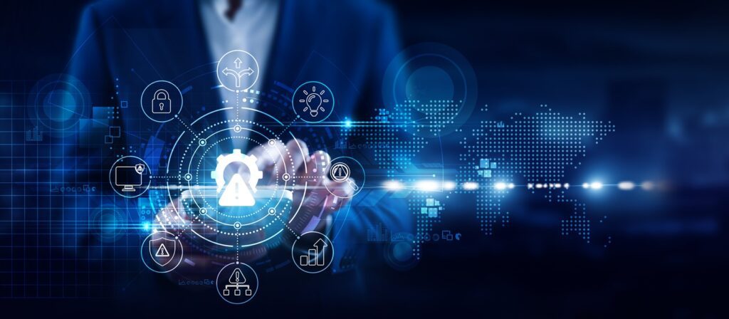 A person in a suit holds out their hands with digital cyber security icons hovering above, including a lock, cloud, shield, and network symbols, set against a dark background with a world map and data elements.