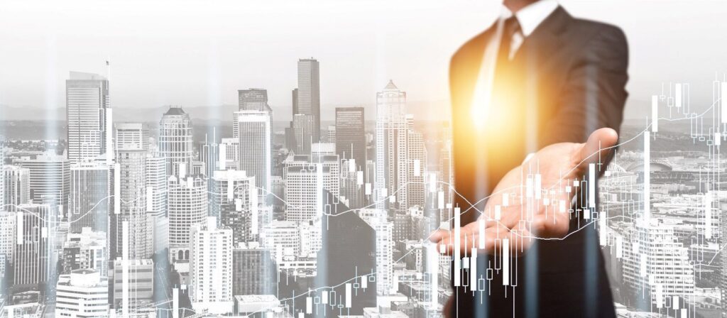 A businessman in a suit holds out his hand with glowing light, superimposed over a city skyline and transparent financial charts, symbolising growth and investment opportunities in an urban environment.