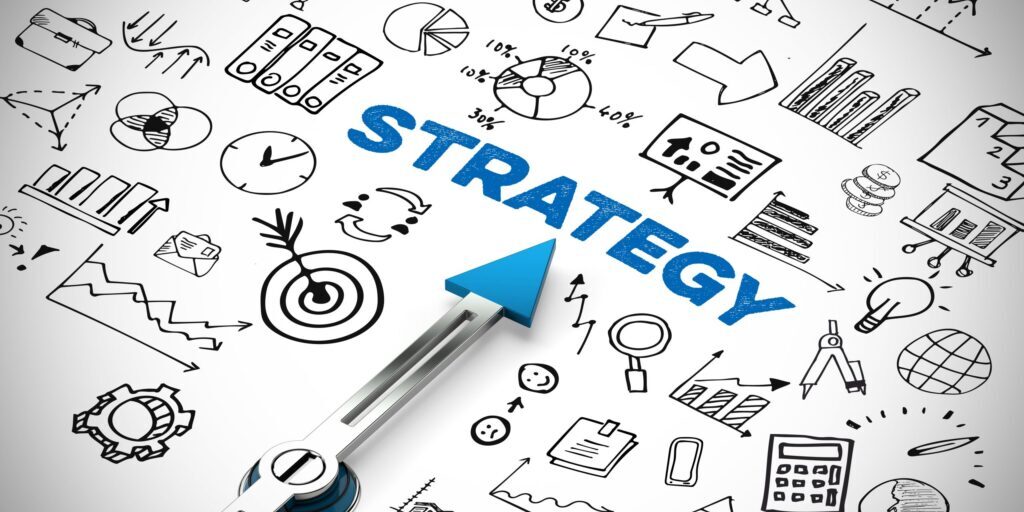 An arrow points to the word STRATEGY surrounded by hand-drawn business icons, including charts, graphs, targets, money, light bulbs, documents, and gears, representing planning and goal setting.
